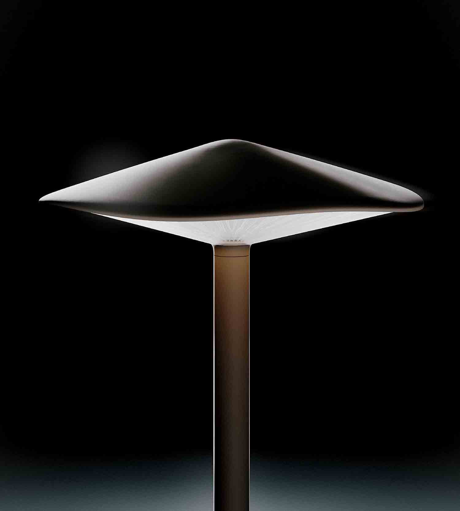 A table lamp with a white base and a black background.