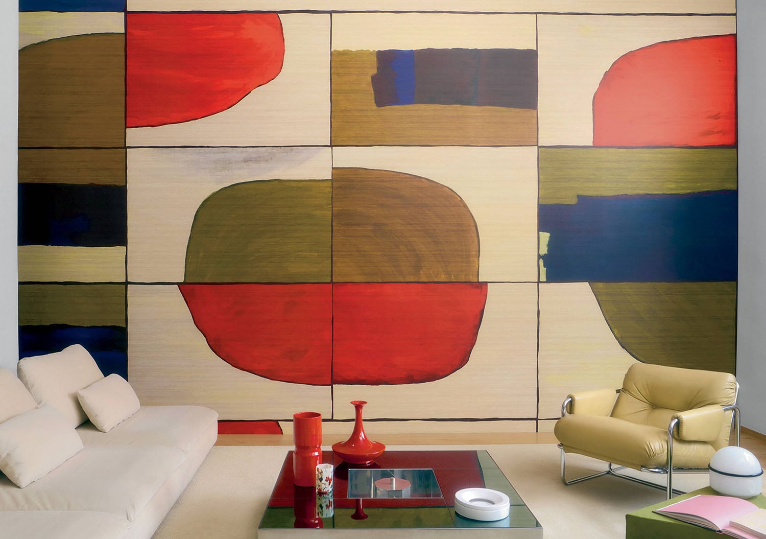 A living room with a couch and a painting on the wall.