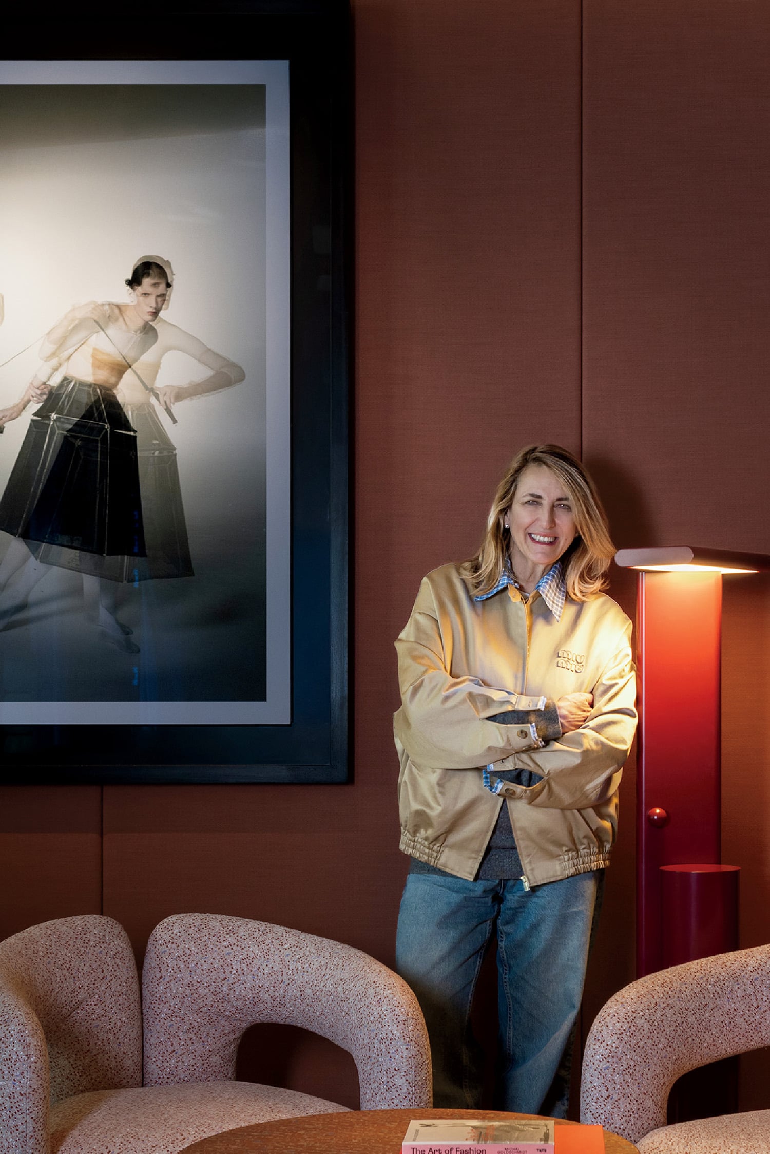A woman standing in a room with a picture of a woman