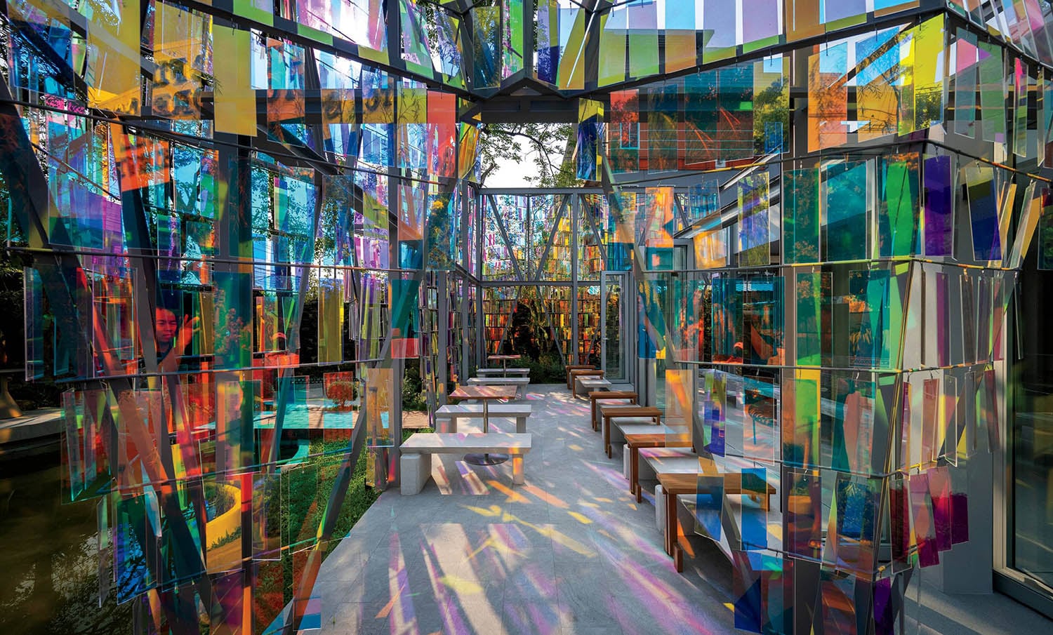 A colorful art installation in a glass walled room.