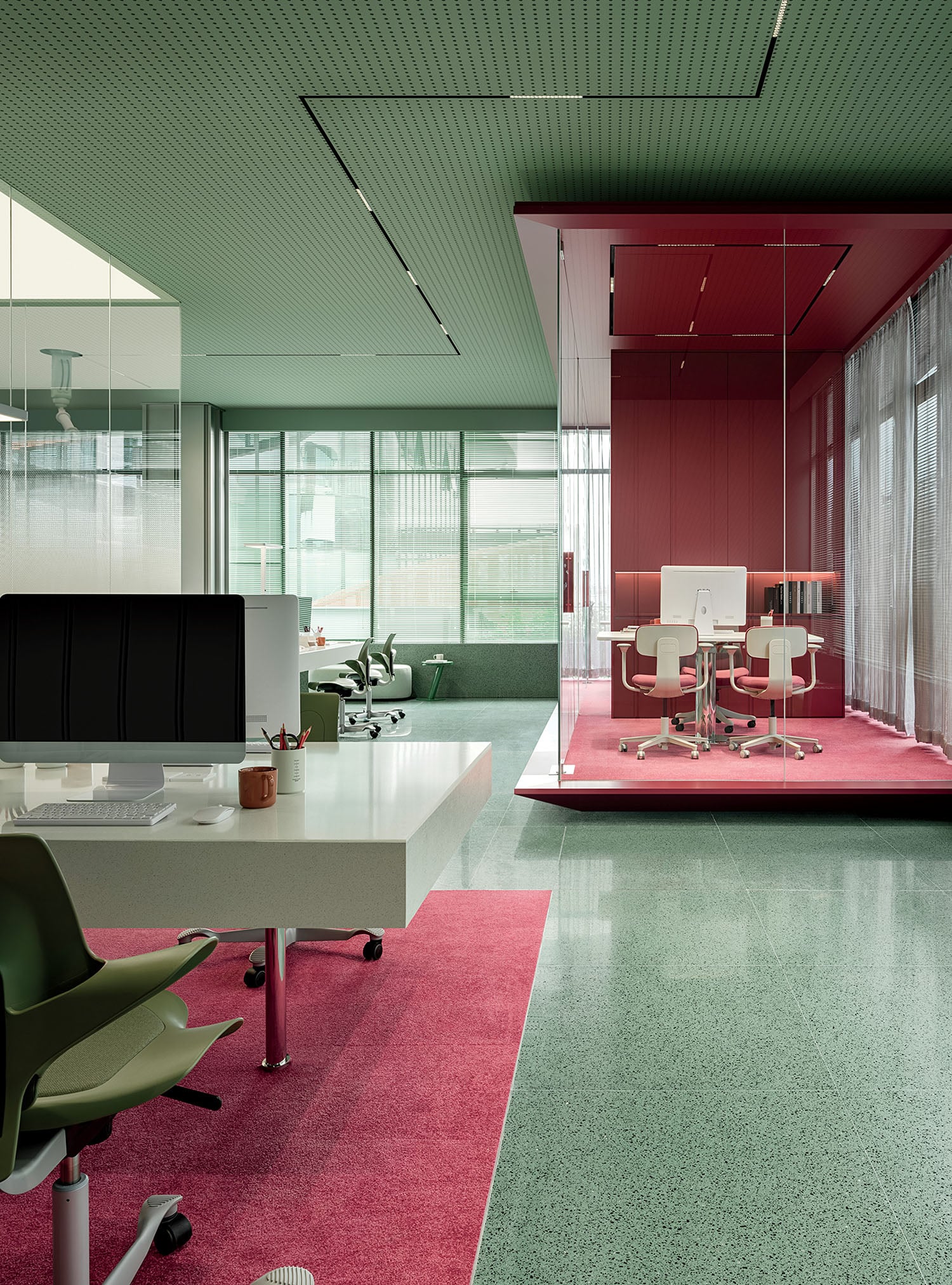 A room with a desk, chair, and computer monitor.