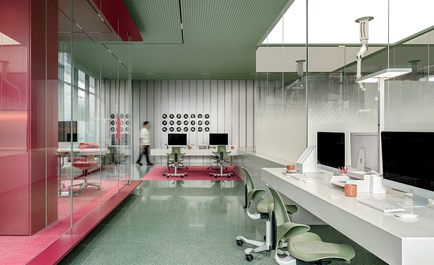 A pink office with a glass wall.