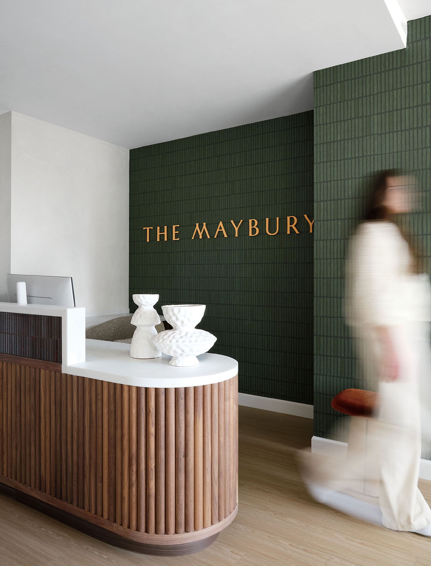 A woman walking past a counter in a store.