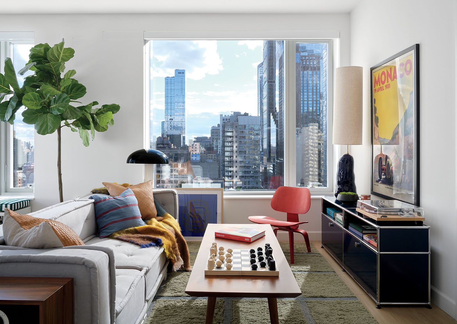 A living room with a couch, coffee table, and a television.