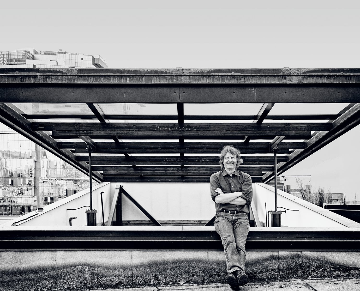 a man sitting on a bench in a city