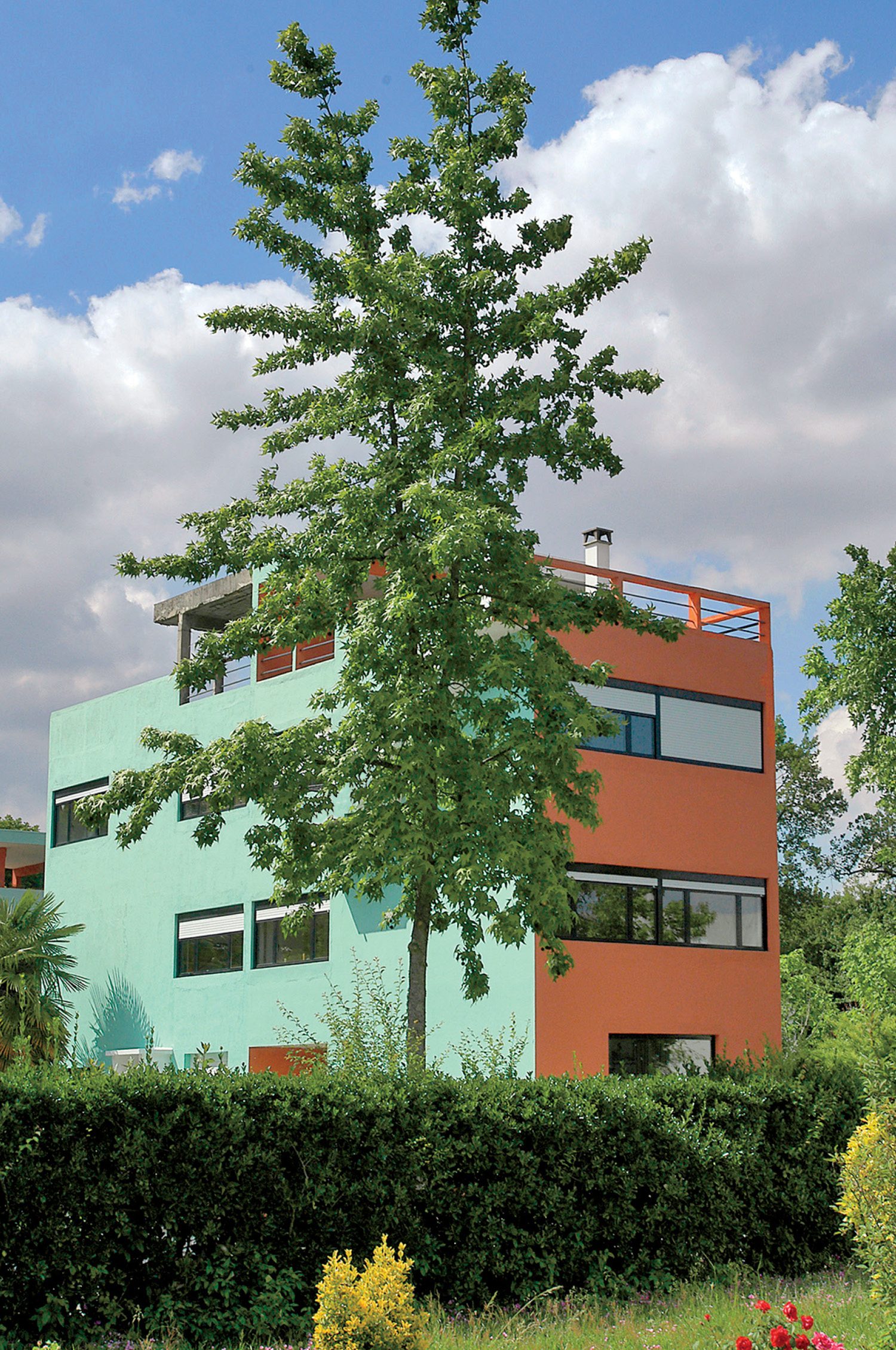 a building with a green and orange facade