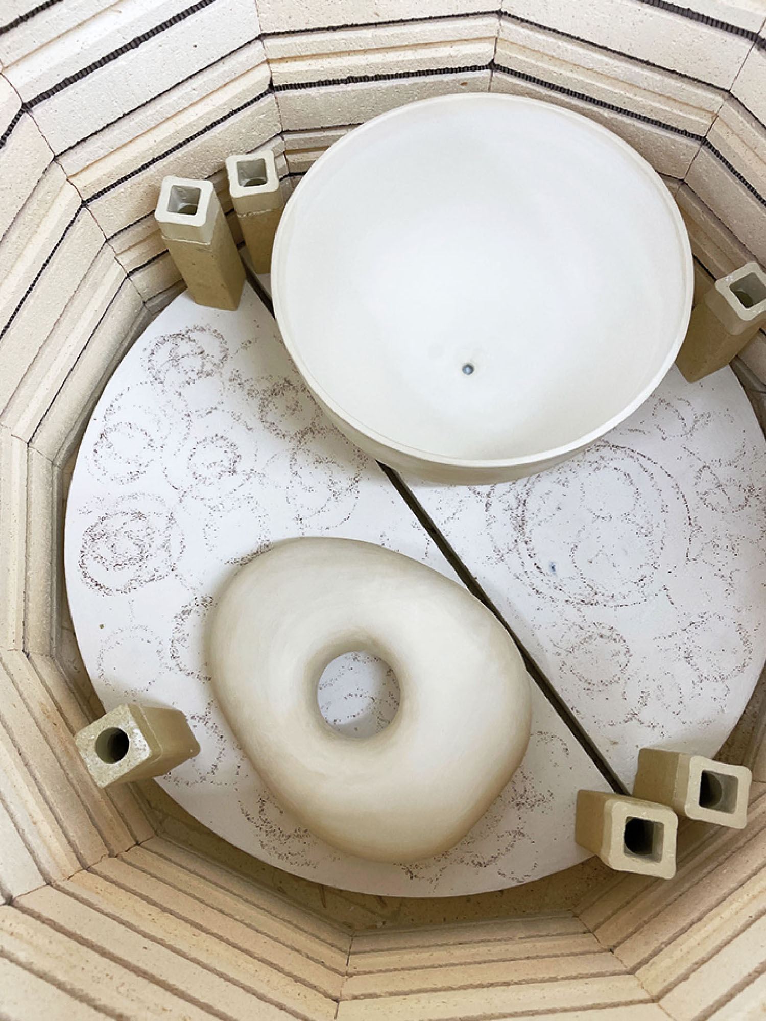 A white vase sitting on top of a wooden table.