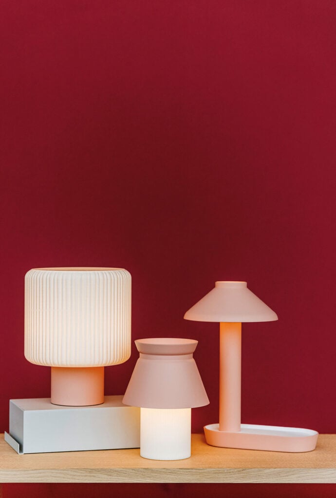 A table with a lamp and a book on it.