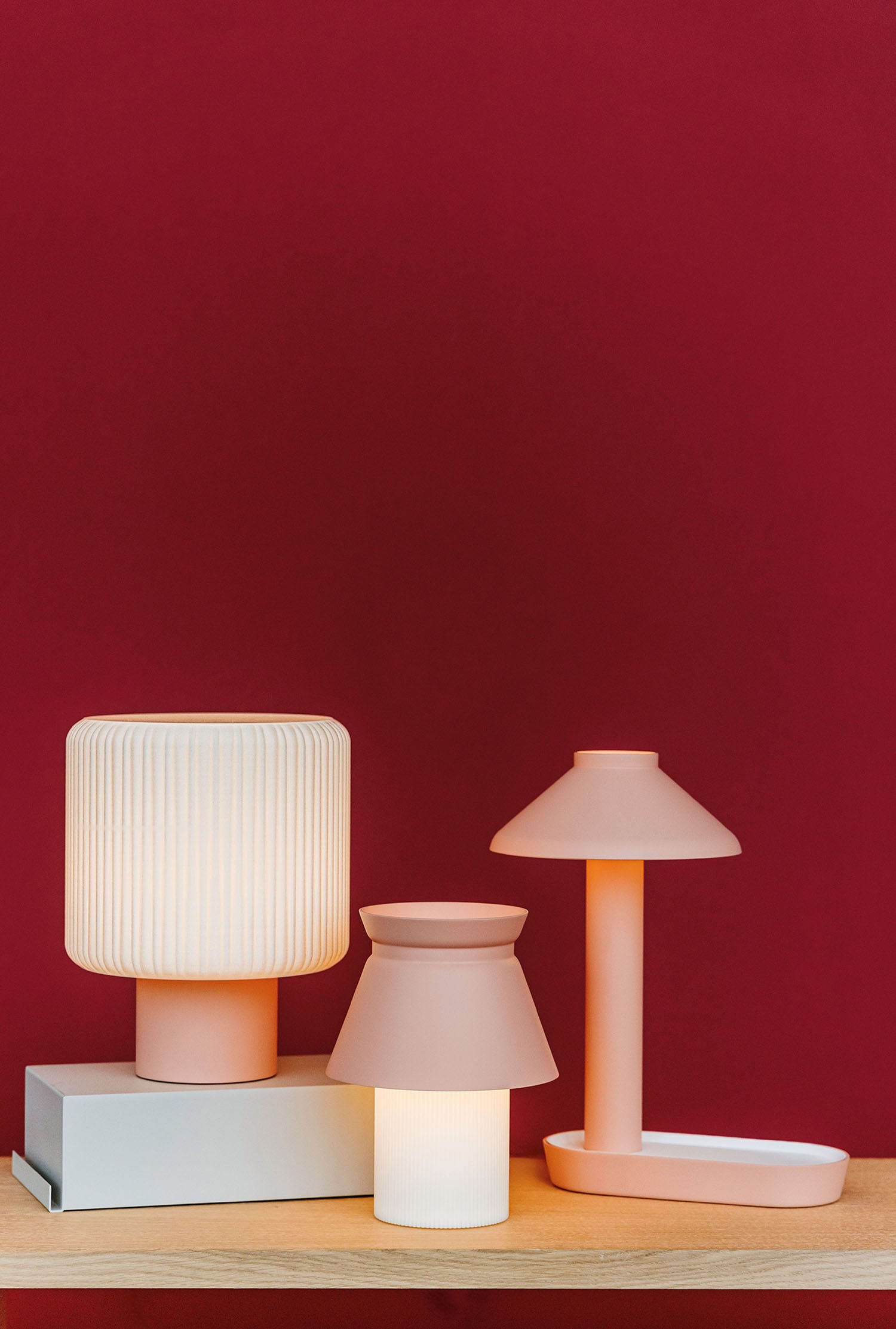 A table with a lamp and a book on it.