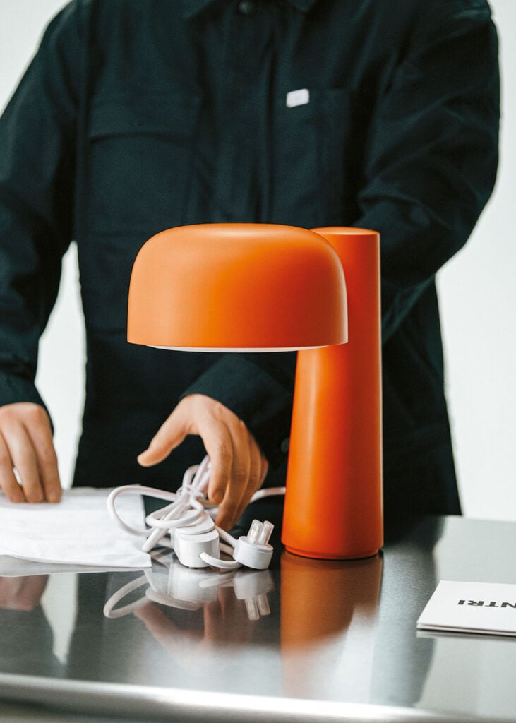 A man is sitting at a table with a laptop.