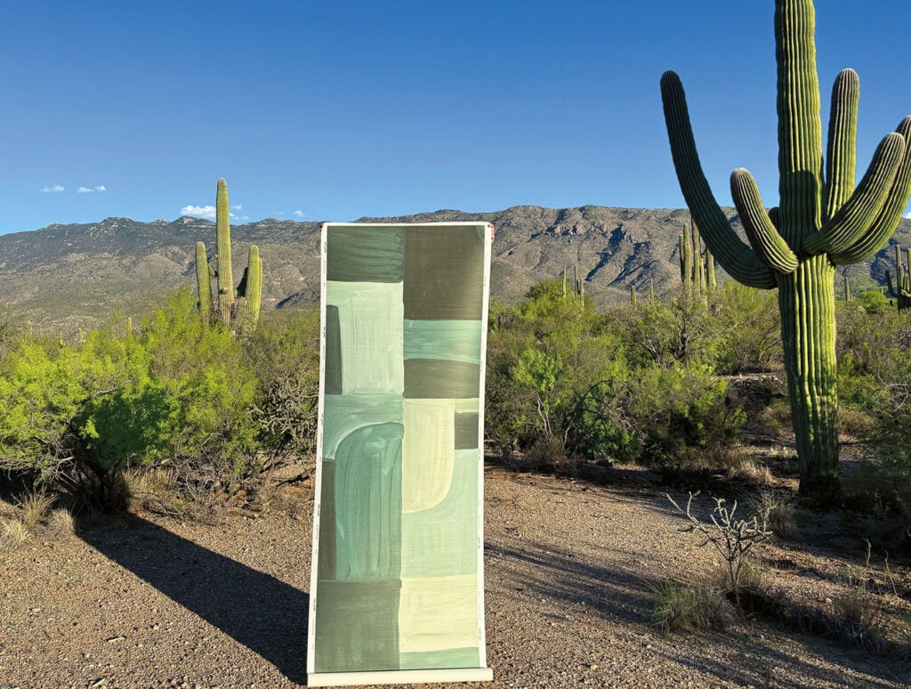 A large green object sitting in the middle of a desert.
