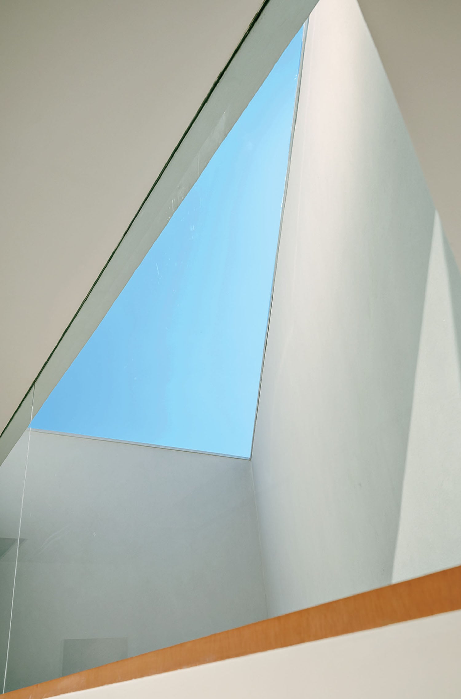 A white wall with a blue sky in the middle.