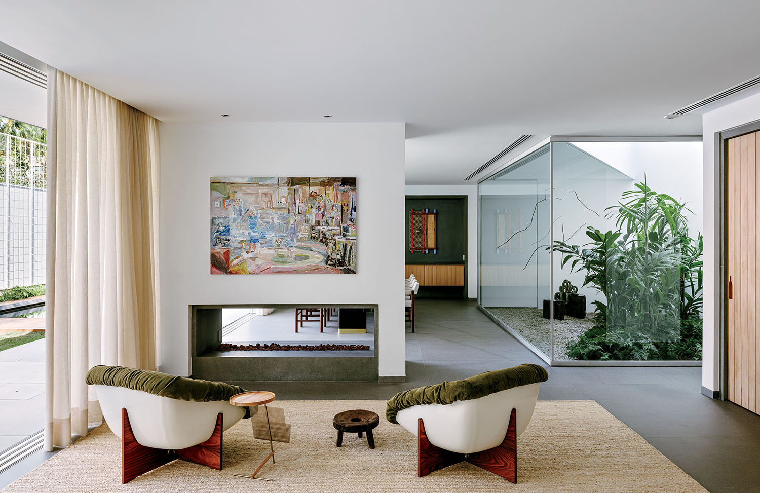 A living room with a large painting on the wall.