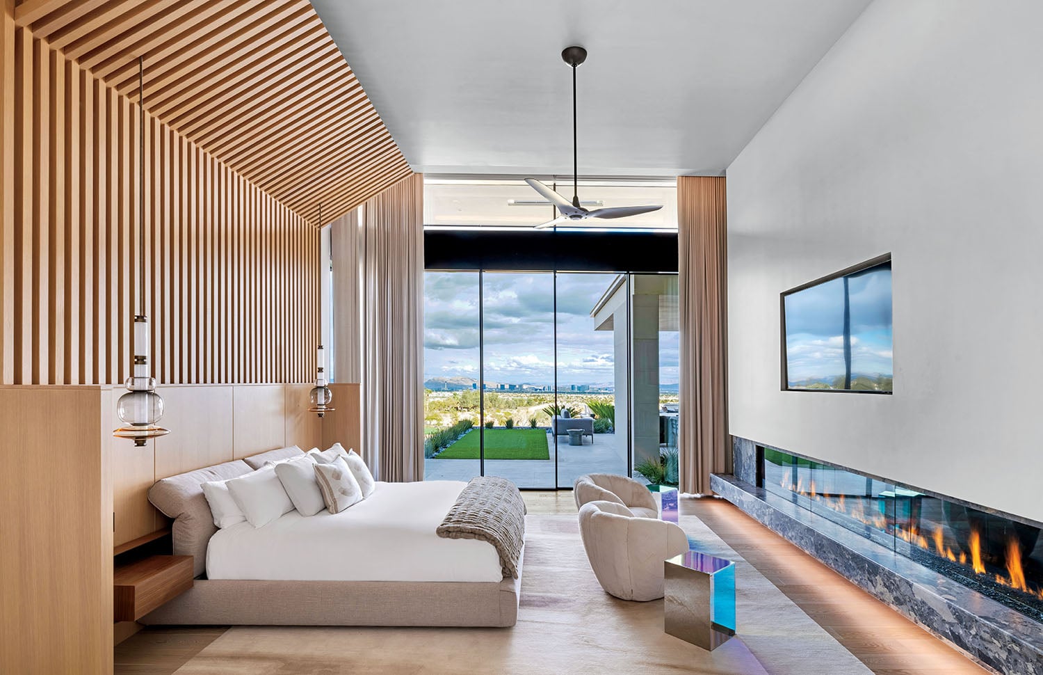 A bedroom with a fireplace and a large bed.