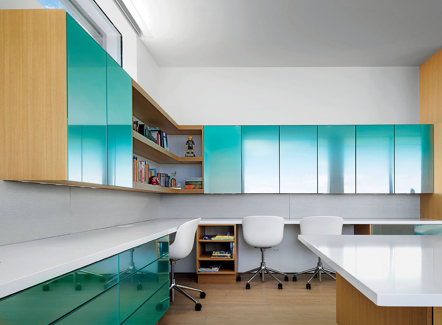 A white desk and a green cabinet.