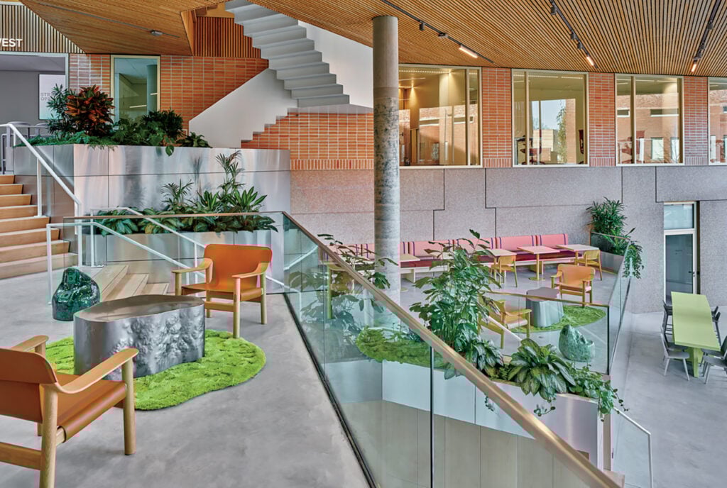 "A room with a staircase, a couch, and a table".