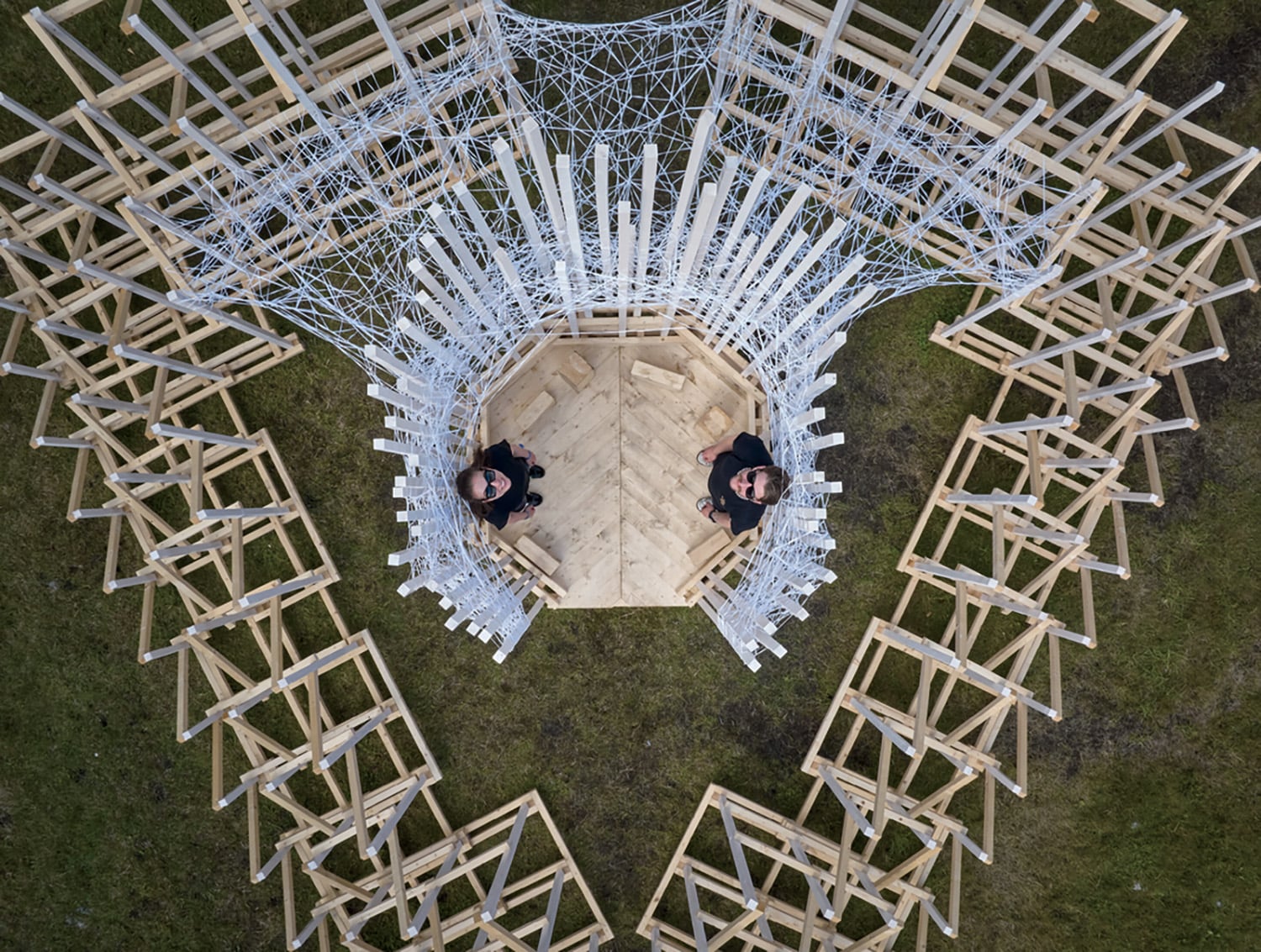A man standing in a circle of chairs.