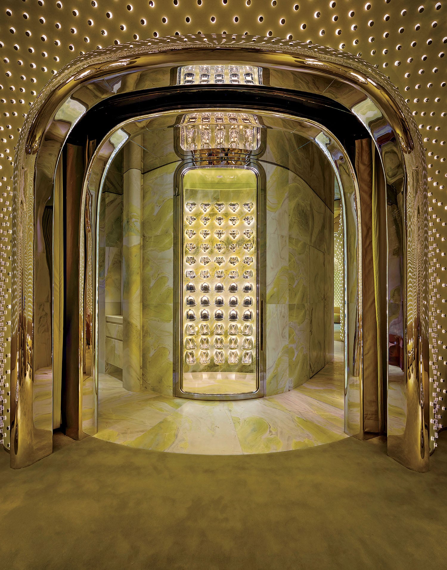 A room with a large mirror and a gold ceiling.