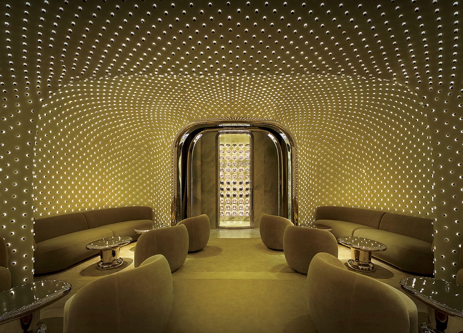 A room with a lot of chairs and a wall of dots.