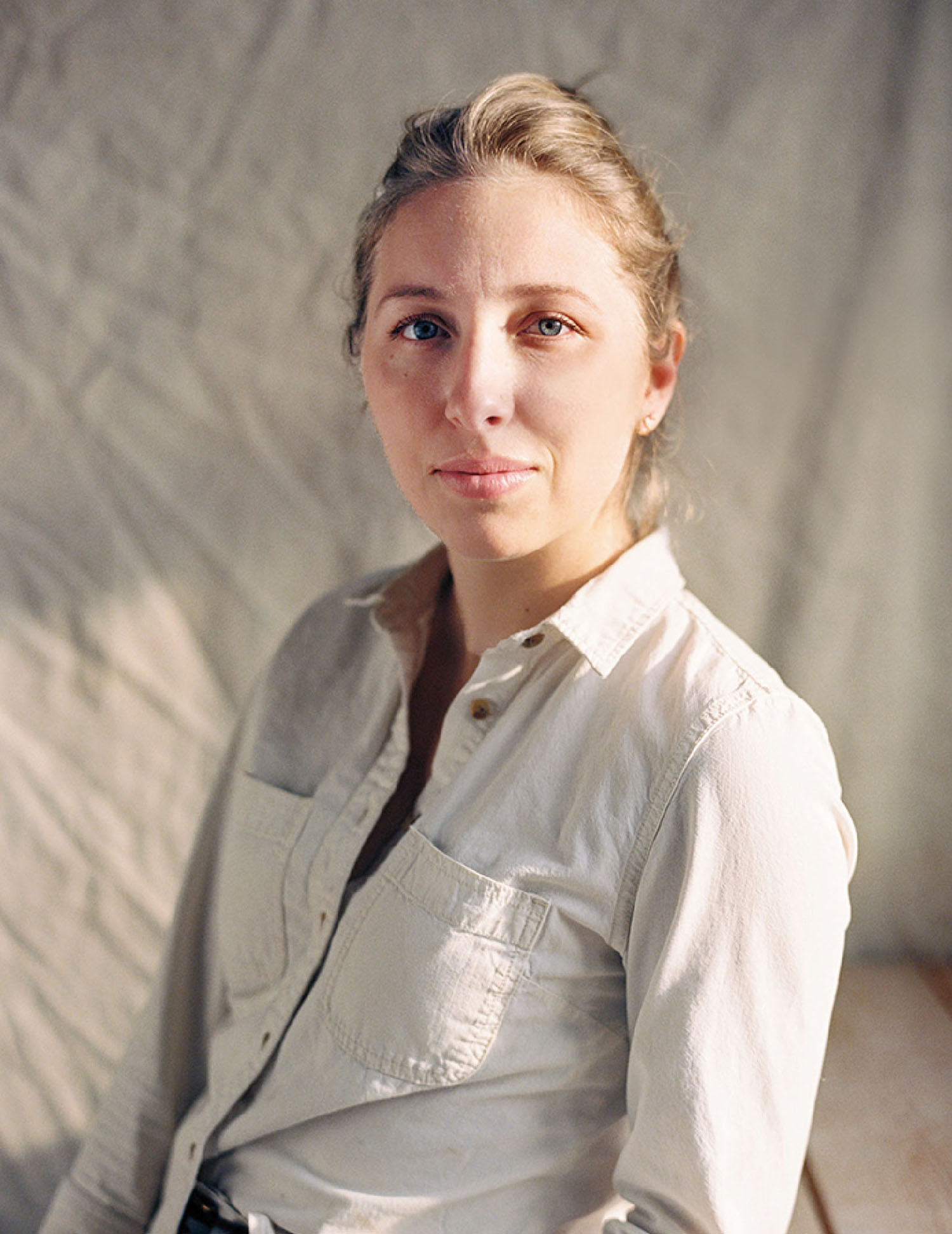 A woman sitting on a bed.