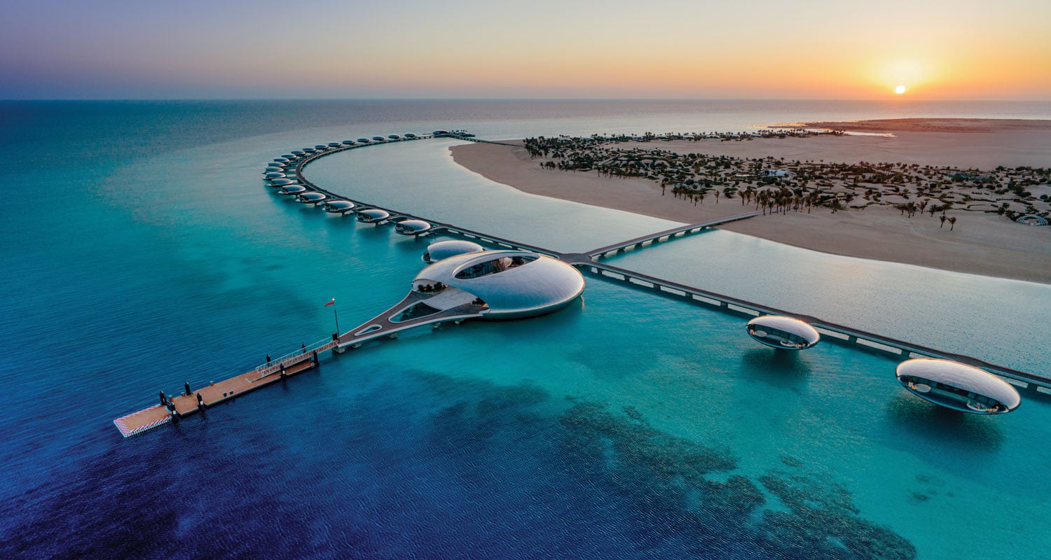 a resort building floating on a blue sea