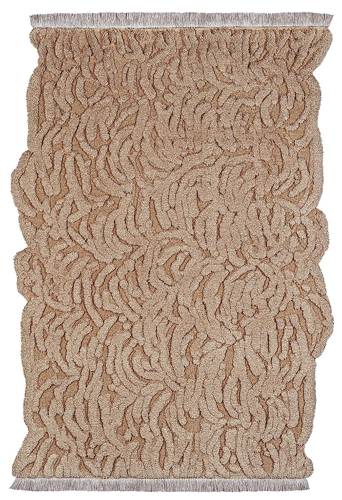 a tan rug iwth intricate pattern in wool