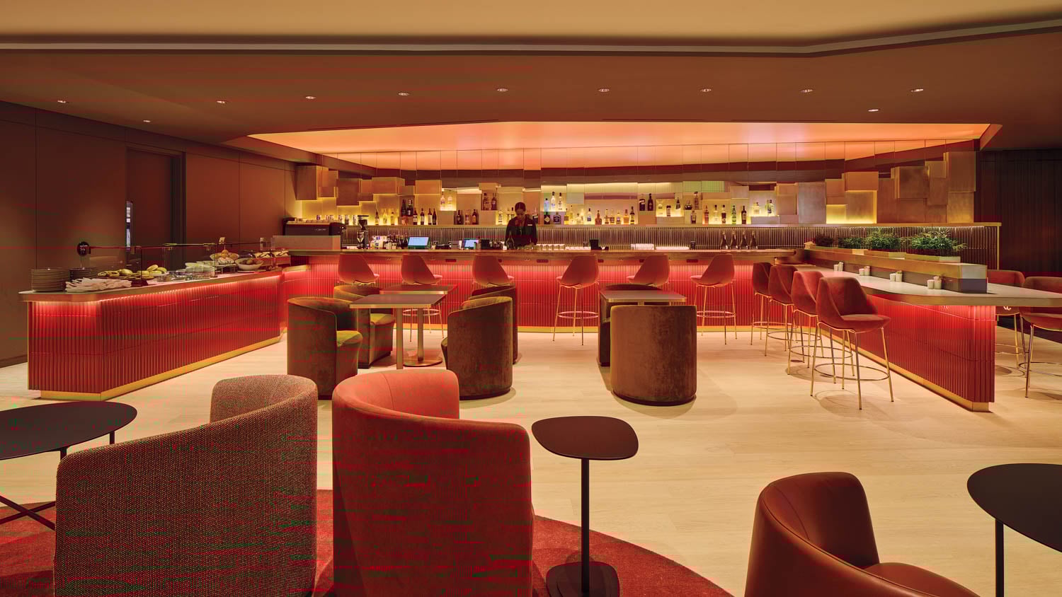 curved red seats in airport lounge