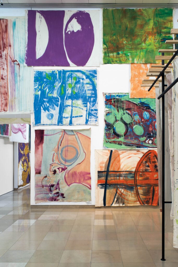 a gallery wall with colorful paintings