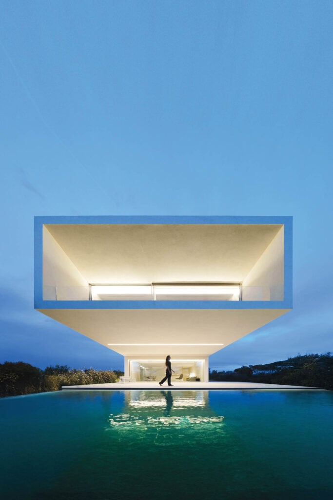 facade of a modern home with rectangular front above reflecting pool