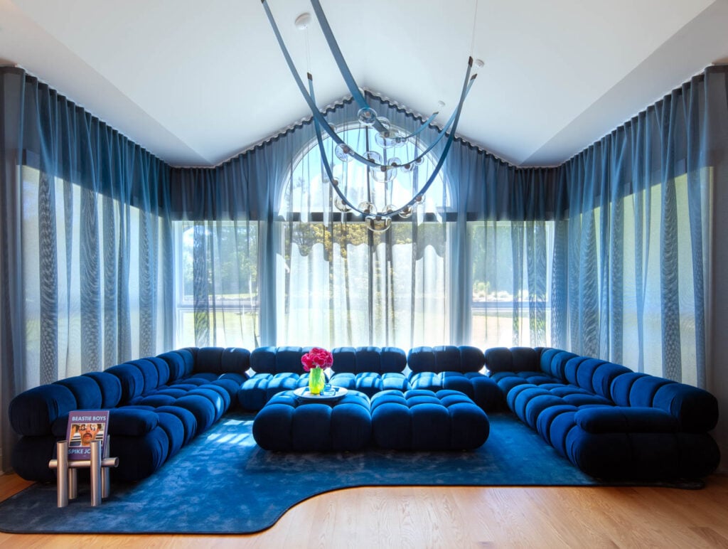 a blue hued room with blue sections and pale blue sheer curtains