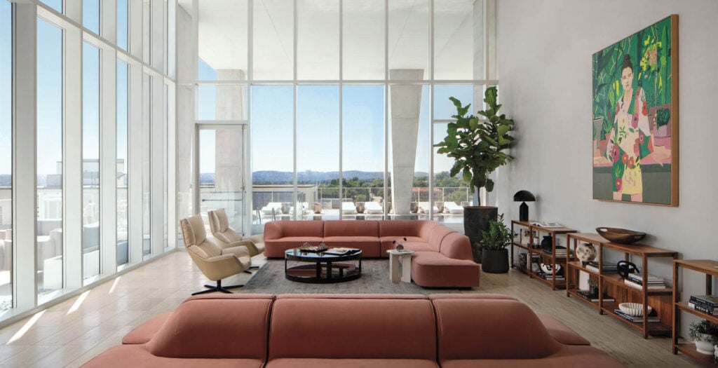 living area with two couches and glass walls