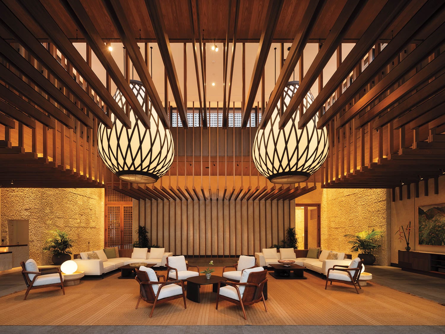 a seating area with two chandeliers 