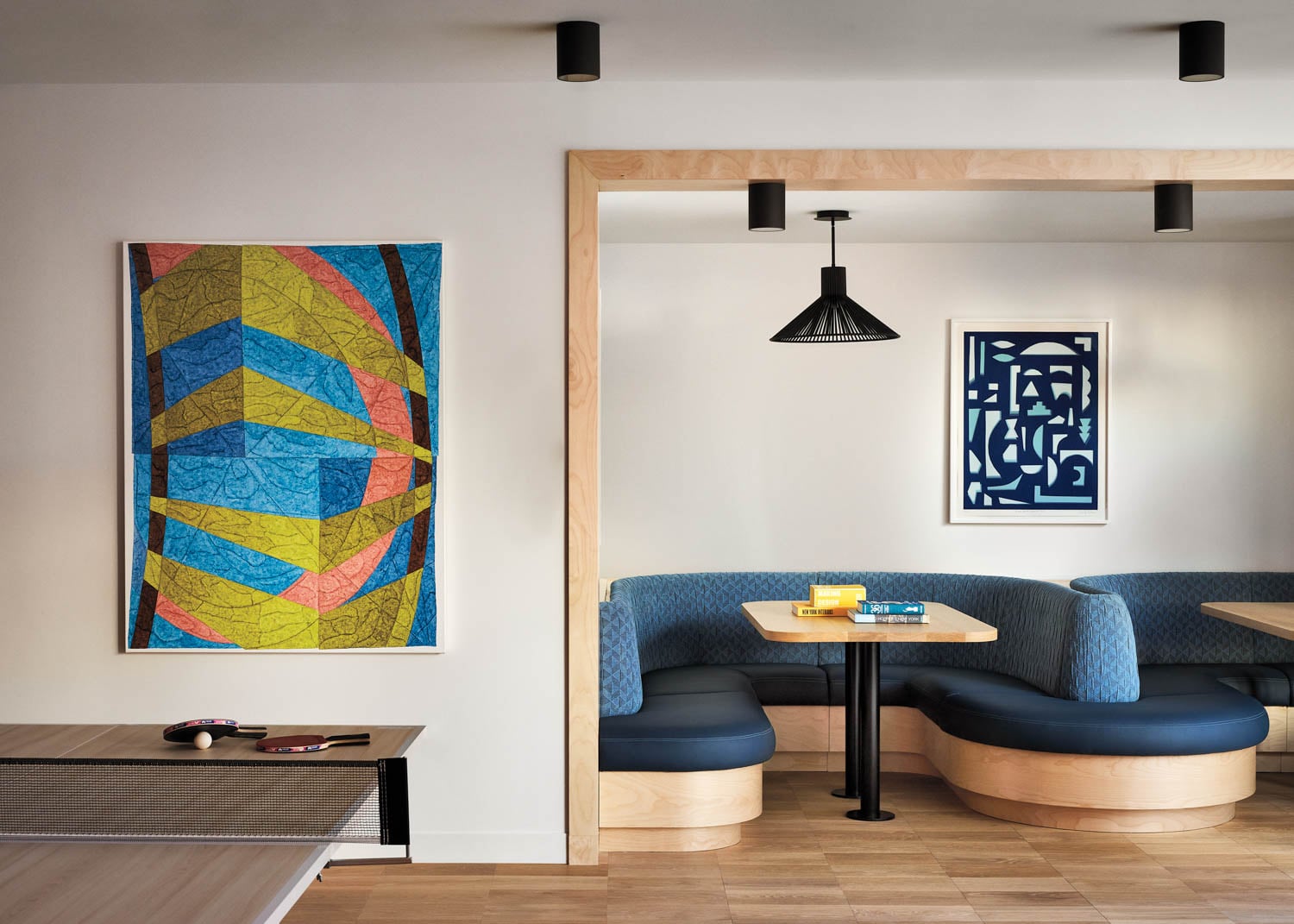 a blue sectional with pendant light