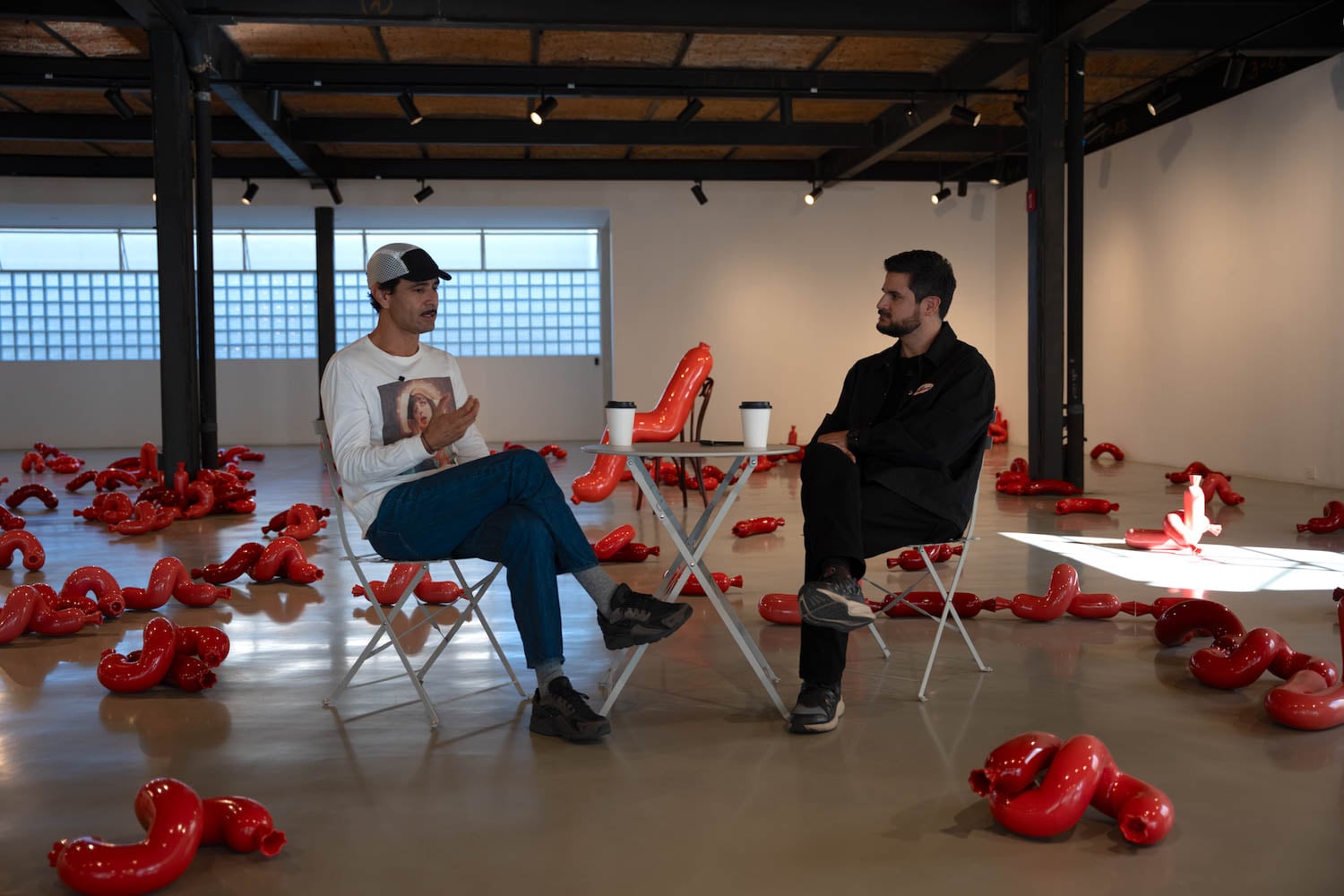 two men talking together in a podcast studio