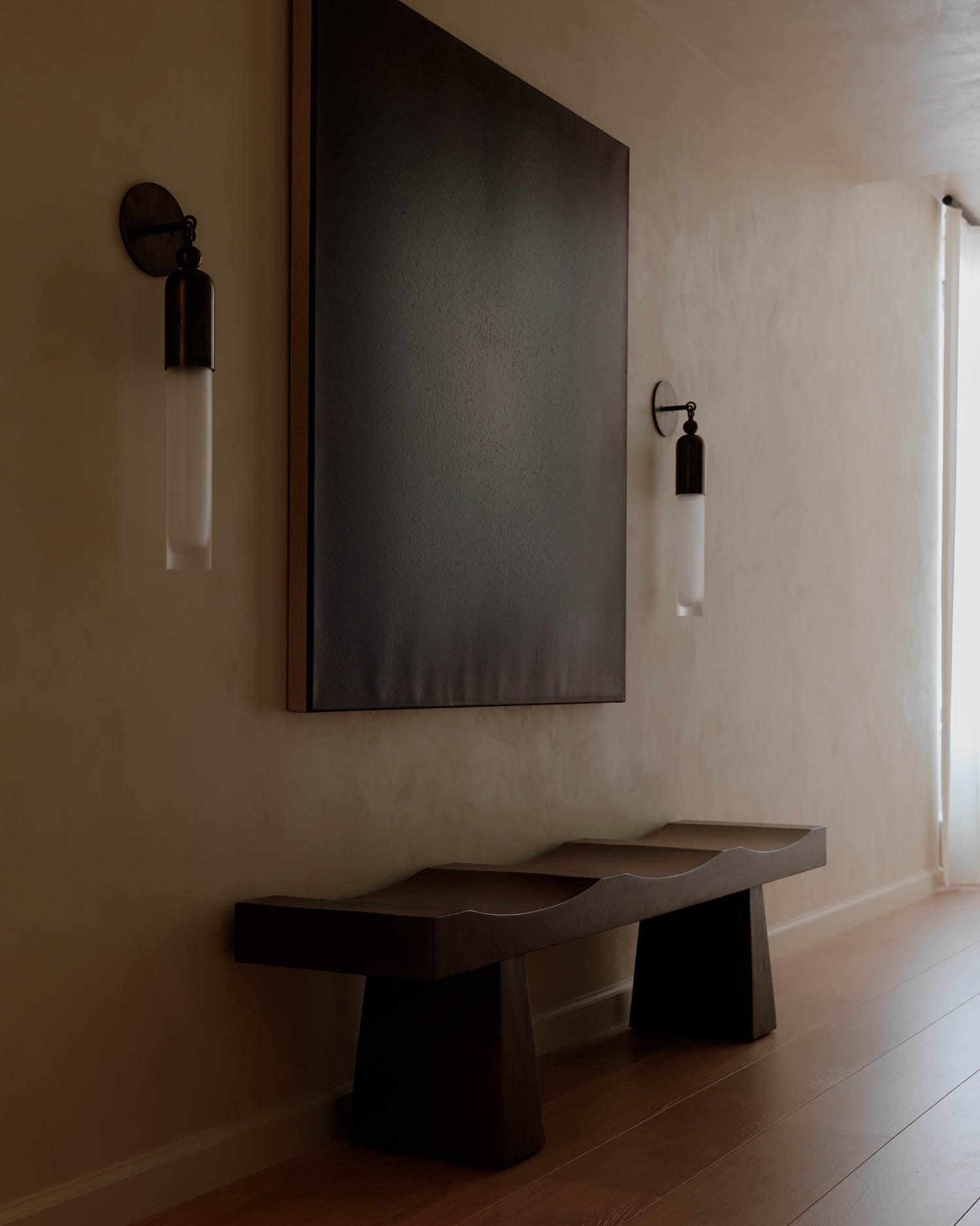 artwork hangs on the side of the entryway