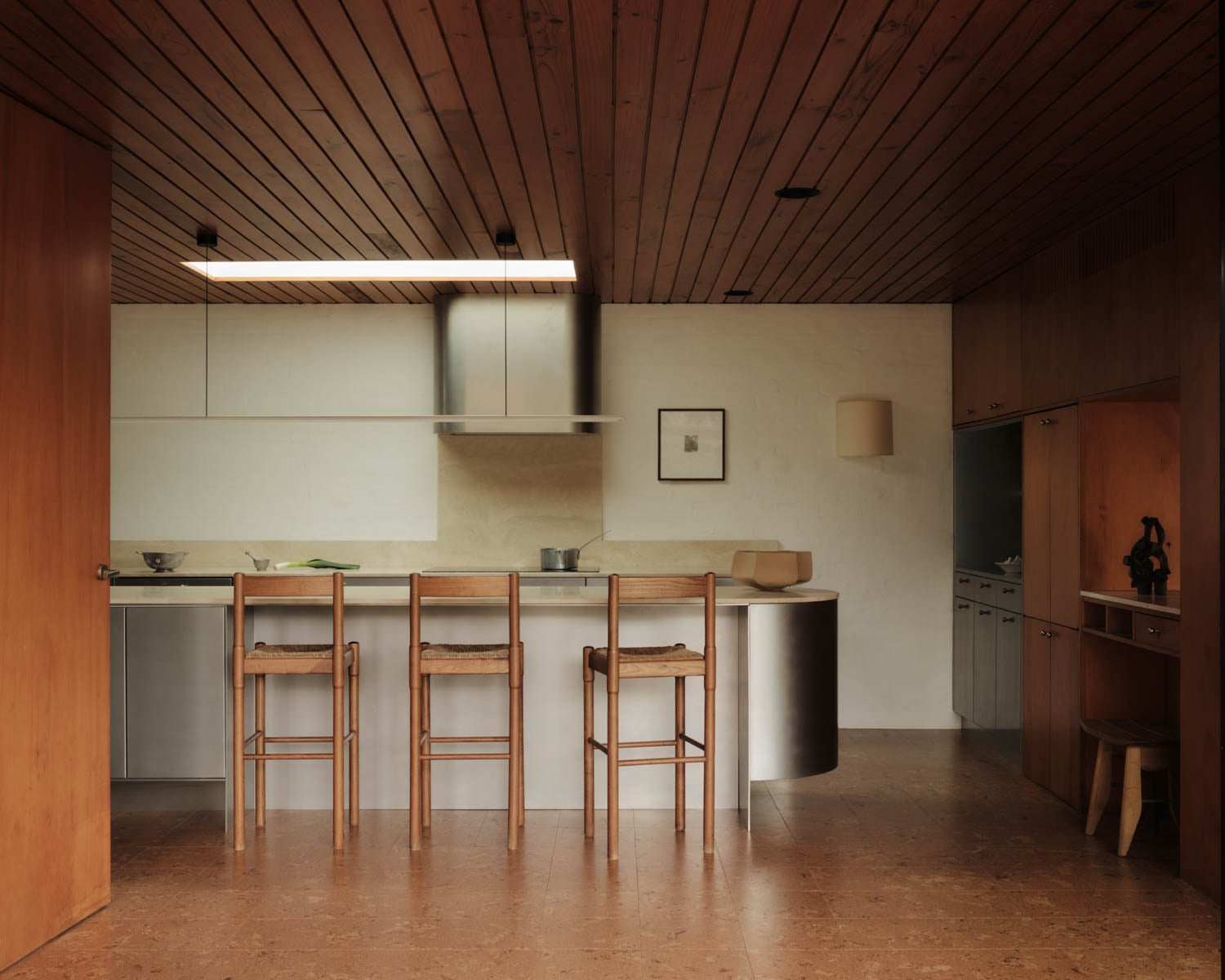 kitchen with wood clad panels and metal island