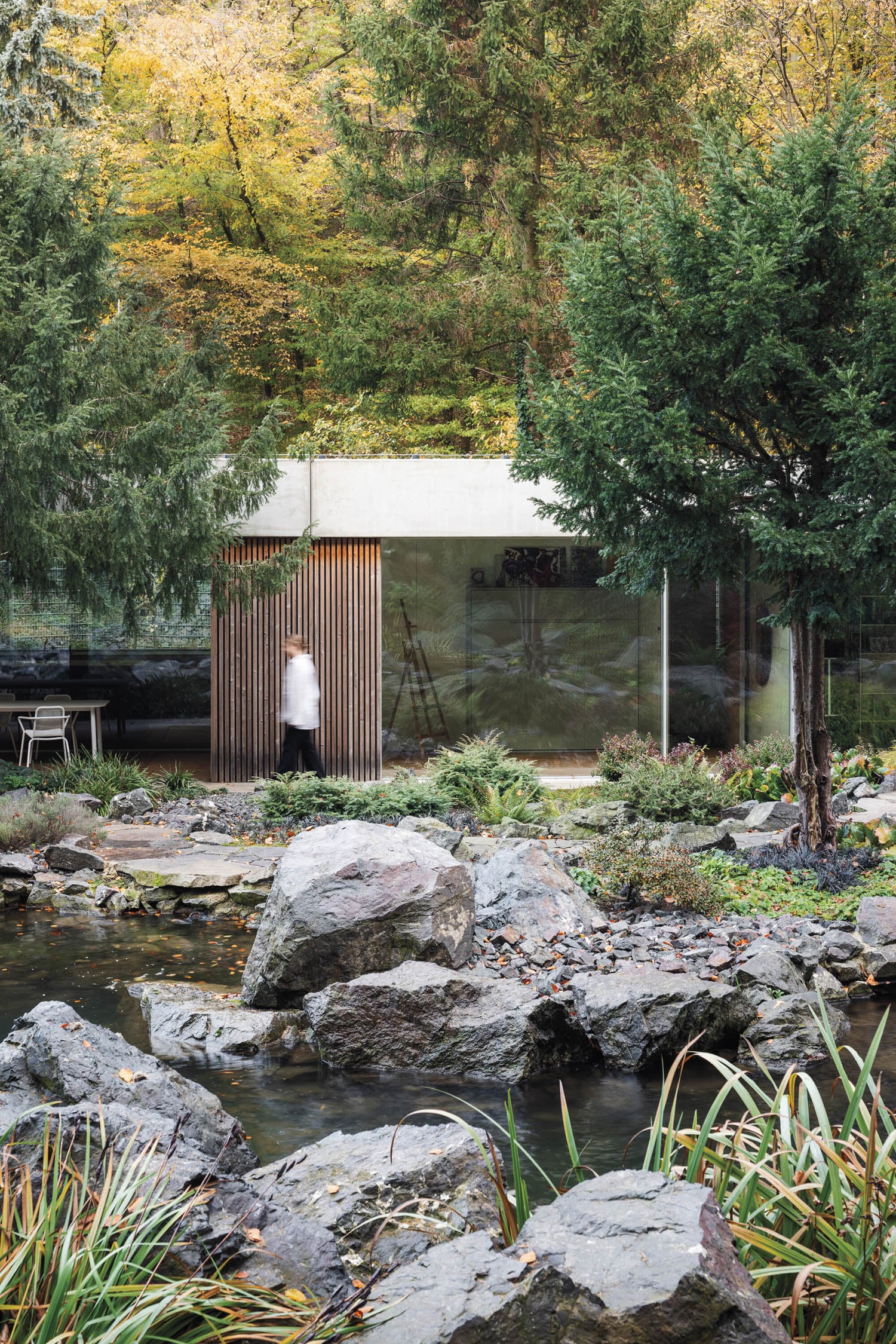 person walking through outdoor garden