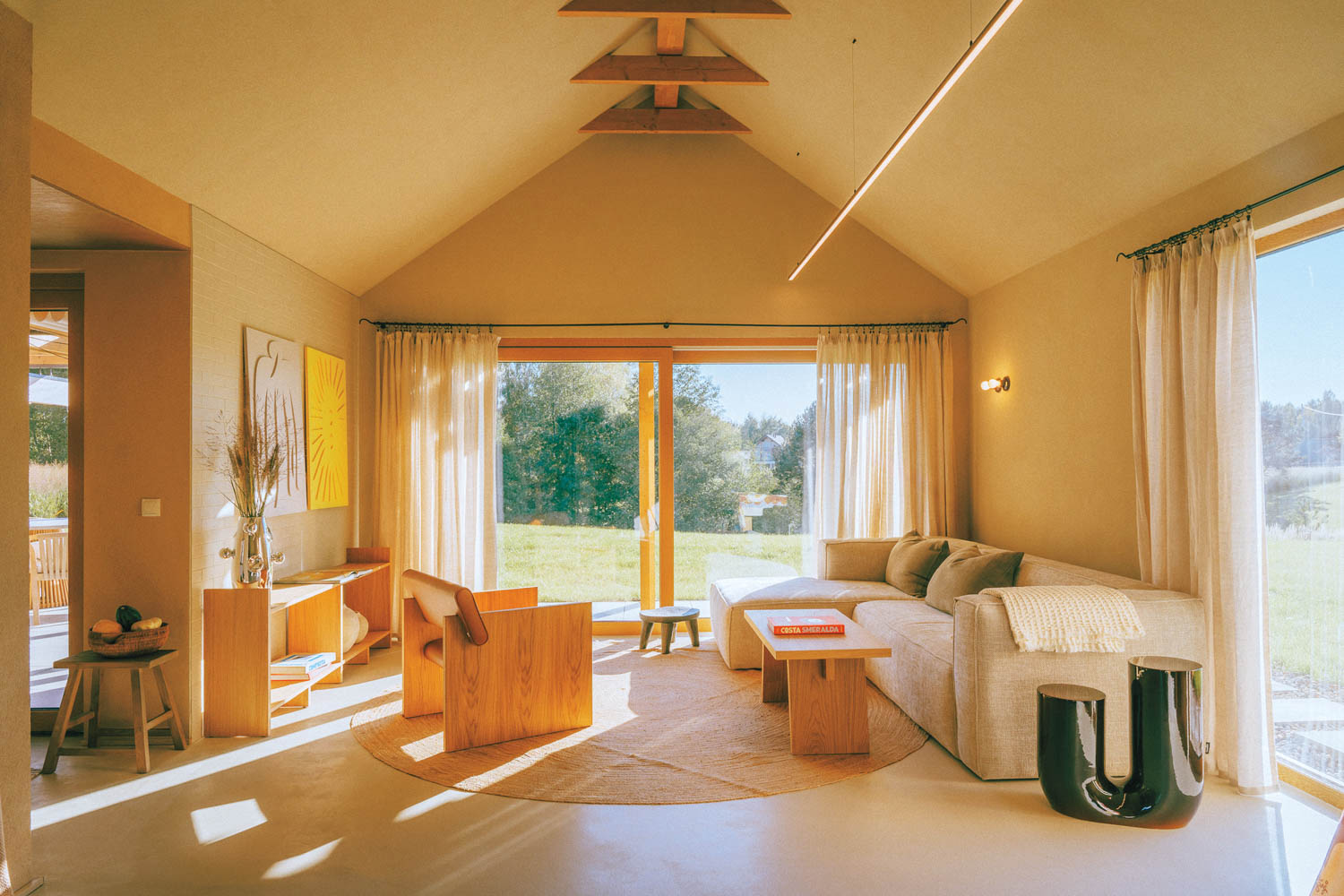 living room area with white couch and a sunlit glow