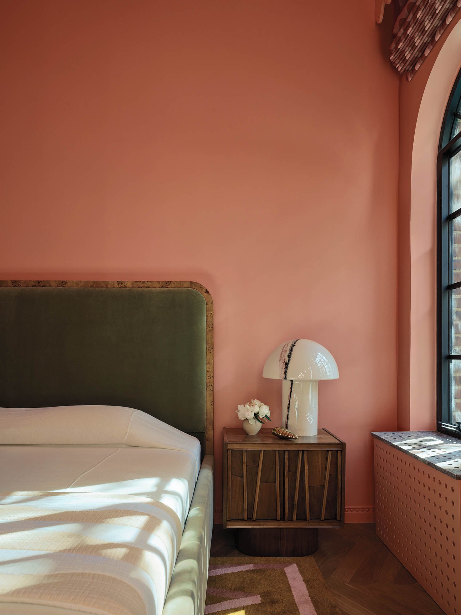 guest room with dark green headboard and green walls