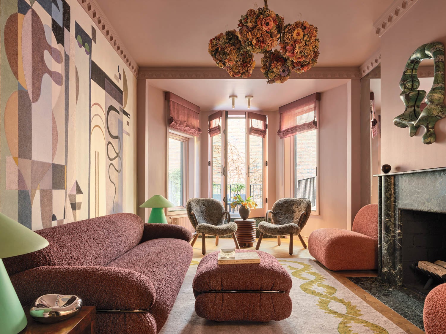 living room with dark pink paint on walls, black fireplace and view to balcony