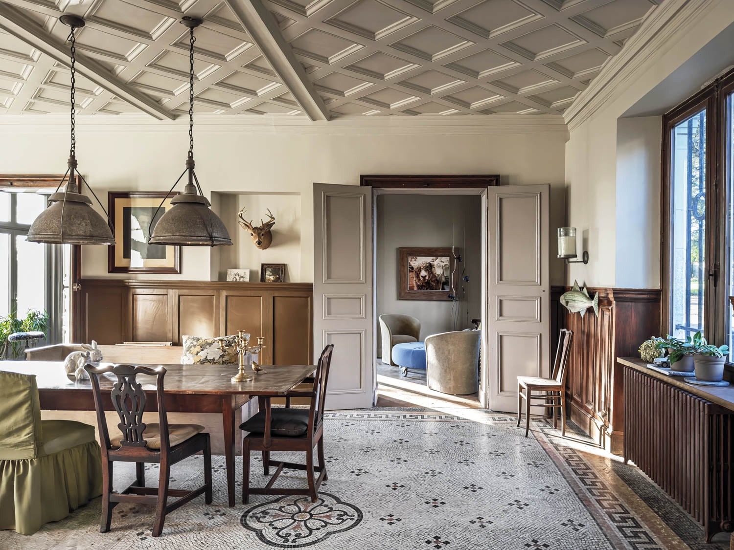 kitchen area with white tile flooring, hanging lights and patterned ceiling