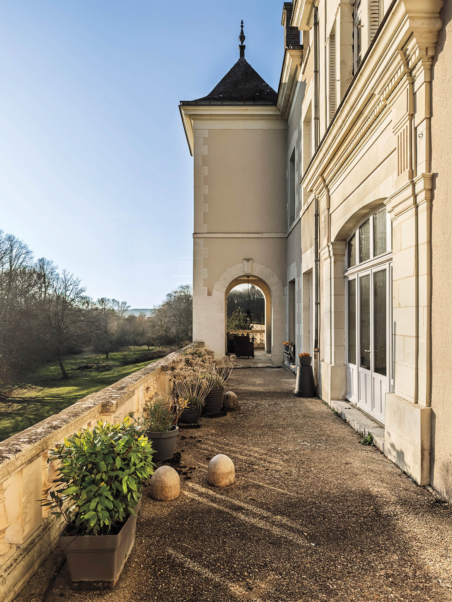 rear terrace of chateau with a mini garden