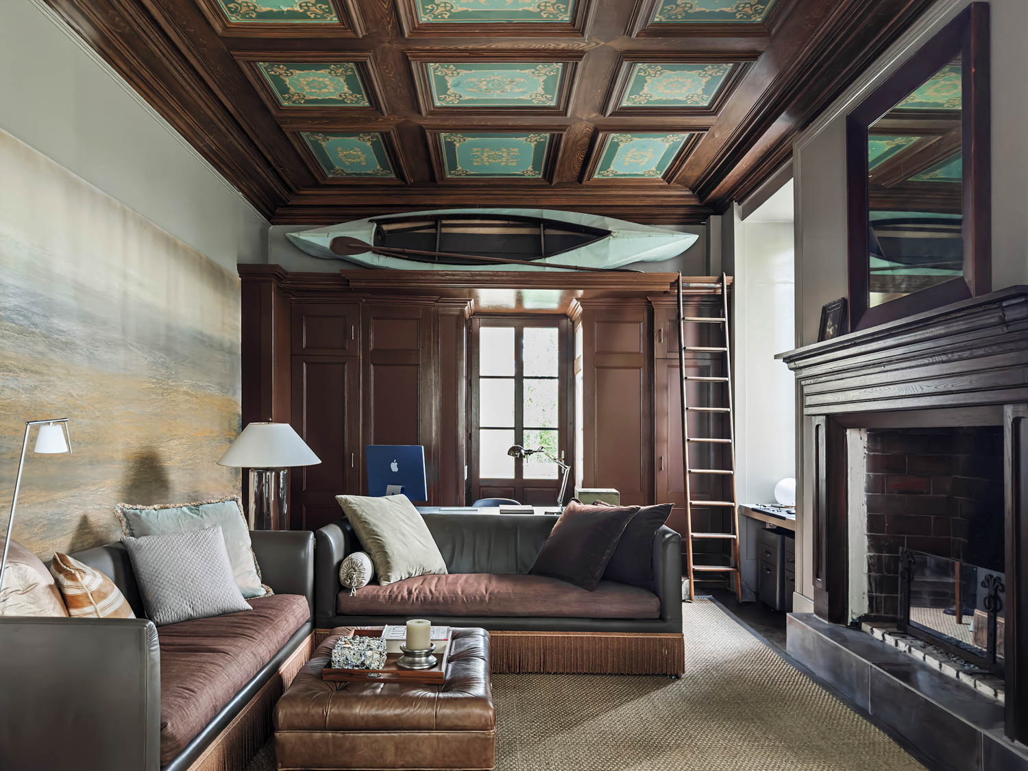 office study area with brown furnishings, black fireplace and patterned ceiling